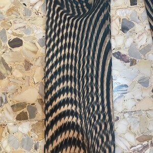 Puede incluir: Primer plano de la parte inferior de un pantal&oacute;n de patr&oacute;n negro y marr&oacute;n. El patr&oacute;n es un dise&ntilde;o abstracto en espiral.