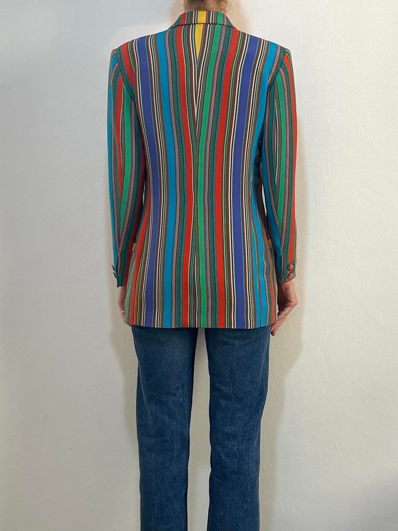 May include: A striped blazer with a variety of colors, including red, blue, green, and yellow. The blazer is made of a lightweight fabric and has a relaxed fit.