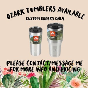 May include: Two stainless steel Ozark Trail tumblers with black lids. The tumblers have a mountain scene and the words "Ozark Trail" and "Tumbler" printed on them. The text "OZARK TUMBLERS AVAILABLE CUSTOM ORDERS ONLY PLEASE CONTACT/MESSAGE ME FOR MORE INFO AND PRICING" is printed on the image.