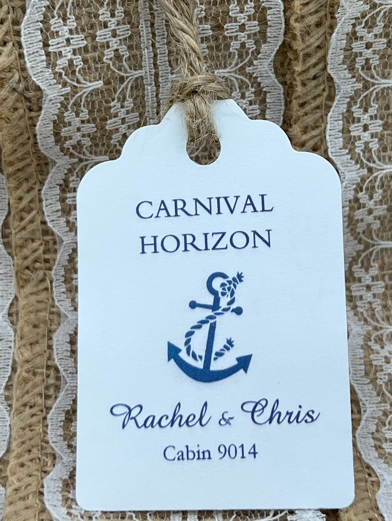 May include: White tag with blue text and an anchor graphic. The text reads "Carnival Horizon" and "Rachel & Chris" with "Cabin 9014" below.