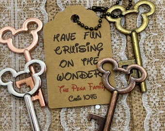 May include: Three Mickey Mouse shaped bottle openers with a brown tag that reads "Have Fun Cruising on the Wonder The Pena Family Cabin 1045".