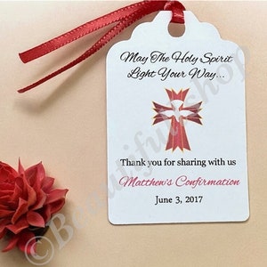 May include: White favor tag with a red cross and dove design. The text reads "May The Holy Spirit Light Your Way... Thank you for sharing with us Matthew's Confirmation June 3, 2017".