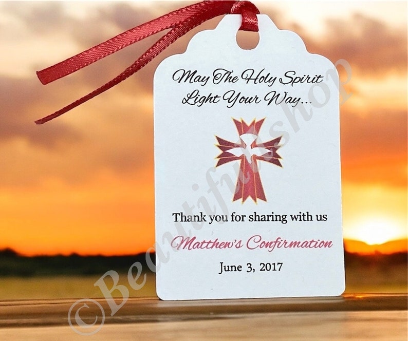 May include: White favor tag with a red and gold cross and dove design. The text reads "May The Holy Spirit Light Your Way... Thank you for sharing with us Matthew's Confirmation June 3, 2017".