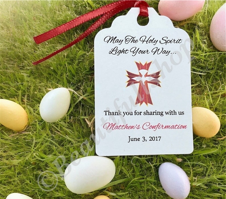 May include: White favor tag with a red cross and dove design. The text reads "May The Holy Spirit Light Your Way... Thank you for sharing with us Matthew's Confirmation June 3, 2017".