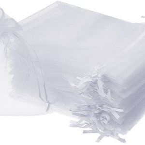 May include: A stack of white sheer organza gift bags with drawstrings. The bags are made of a delicate, translucent fabric and are perfect for packaging small gifts or favors.