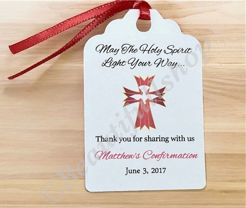 May include: White favor tag with a red cross and dove design. The text reads "May The Holy Spirit Light Your Way... Thank you for sharing with us Matthew's Confirmation June 3, 2017".