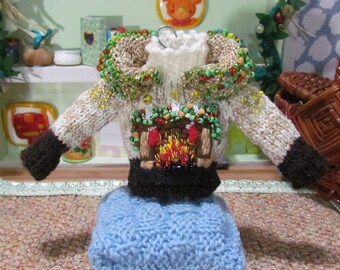 Decoração de Natal em miniatura para suéter junto à lareira