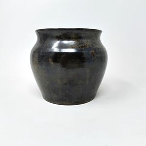 May include: A set of three ceramic mugs with a speckled, matte finish. The mugs are in cream, light grey, and dark grey. Each mug has a simple, minimalist design and a rounded handle.