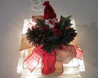 Frosty the Snowman's Clear Decorative Glass Block with burlap ribbon, red berries, pine cones, and white lights.