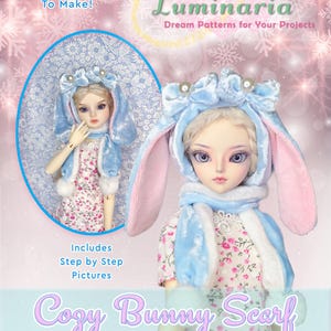 May include: A doll wearing a blue bunny scarf and hat, with pink inner ears, and a floral dress. The image includes the text "Very Easy To Make!" and "Cozy Bunny Scarf" and "Sewing Pattern for 16" Fairyland Minifee & Ellowyne."