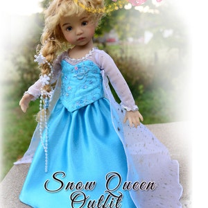 May include: A sewing pattern for a Snow Queen outfit for a 13 inch Dianna Effner's Little Darling doll. The doll is wearing a blue and white dress with a cape and a snowflake hair accessory.