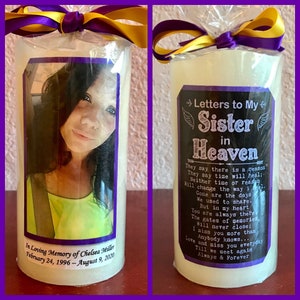 May include: A white candle with a purple and yellow ribbon. The candle has a photo of a woman on one side and a message that reads "Letters to My Sister in Heaven" on the other side. The message includes a poem about loss and grief. The candle is a memorial gift for a loved one who has passed away.