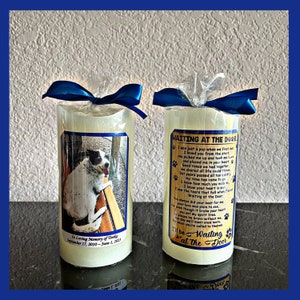 May include: Two white pillar candles with a photo of a dog on one and a poem about a dog on the other. The candle on the left has the text "In Loving Memory of Tinks September 17, 2010 - June 1, 2023". The candle on the right has the text "Waiting at the Door".