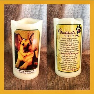May include: A white candle with a photo of a German Shepherd dog and a poem about a pet's passing. The poem reads "Pawprints Left By You..." and includes the dates "02/14/2000-09/16/2014".
