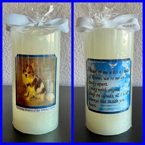 May include: A white pillar candle with a photo of a small dog and the text "In Loving Memory of Rye Whiskey Clifford". The other side of the candle has a blue and white background with the text "Think of me with a smile I know, we're never really apart. I play with angels, I sleep on clouds, & I will always live inside your heart."
