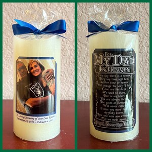 May include: A white pillar candle with a black and white photo of a couple and a black and white label with the text "For My Dad In Heaven" and a poem about grief and loss. The candle is wrapped in clear plastic with a blue ribbon.