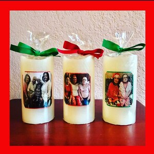 May include: Three white pillar candles with personalized photos of families. Each candle is wrapped in clear cellophane with a green, red, or green ribbon.