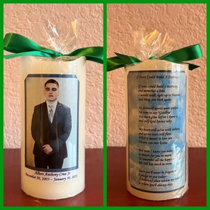 May include: A white candle with a photo of a young man in a suit and tie. The candle has a poem printed on it that reads "If tears could build a stairway, and memories a lane. I would walk right up to Heaven and bring you back again." The candle is wrapped in a green ribbon.