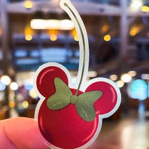 Minnie Mouse stickers of a dark red cherry shaped like Minnie, part of a Disney stickers collection that includes waterproof outdoor stickers.