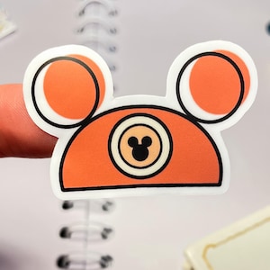 A waterproof vinyl Mickey hat sticker in and orange-rust color, one of a collection of Disney stickers for water bottles.