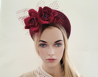 May include: A burgundy velvet headband with a burgundy mesh and two burgundy fabric roses.