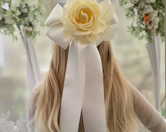 Ivory Bow Flower Fascinator on a sinamay base with hair clip, 10 cms with Silk Flower and ribbon tails