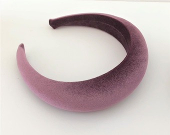 May include: A wide, plush headband made of mauve velvet. The headband is thick and has a smooth, soft texture.