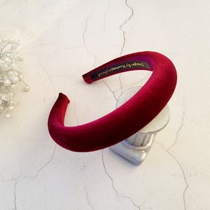 May include: A wide, burgundy velvet headband with the text "Darling by Hummingbird" printed on the inside.