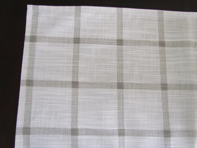 May include: White fabric with a subtle texture and a brown checkered pattern.