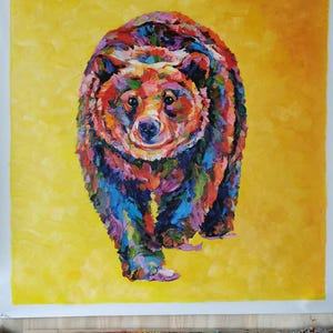 May include: A colorful painting of a bear with a yellow background. The bear is depicted with a variety of colors, including red, blue, green, and purple. The bear is walking towards the viewer.