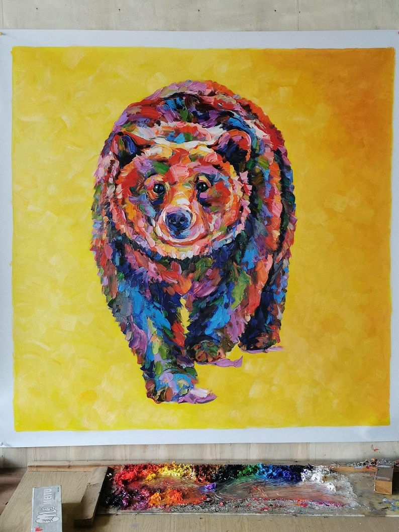 May include: A colorful painting of a bear with a yellow background. The bear is depicted with a variety of colors, including red, blue, green, and purple. The bear is walking towards the viewer.