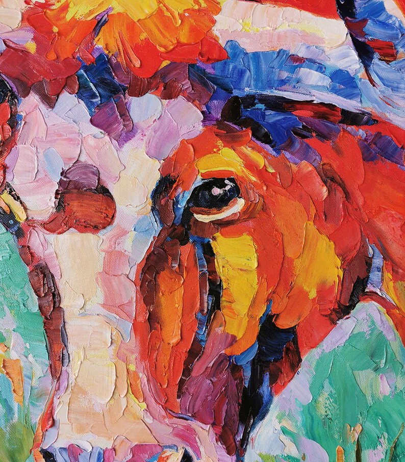 May include: Close-up of a vibrant oil painting of a cow's face. The artwork features thick brushstrokes in shades of red, orange, yellow, blue, and green, creating a textured and expressive effect. The cow's eye is visible.