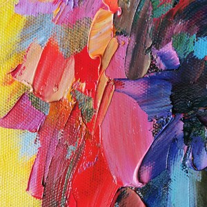May include: Close-up of an abstract oil painting with thick brushstrokes. The artwork features a vibrant palette of colors, including red, pink, yellow, blue, and orange. The texture is heavily impasto, creating a three-dimensional effect.
