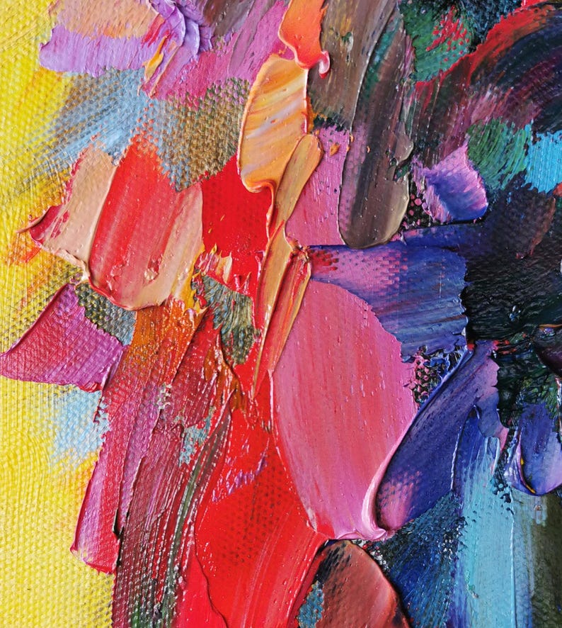 May include: Close-up of an abstract oil painting with thick brushstrokes. The artwork features a vibrant palette of colors, including red, pink, yellow, blue, and orange. The texture is heavily impasto, creating a three-dimensional effect.