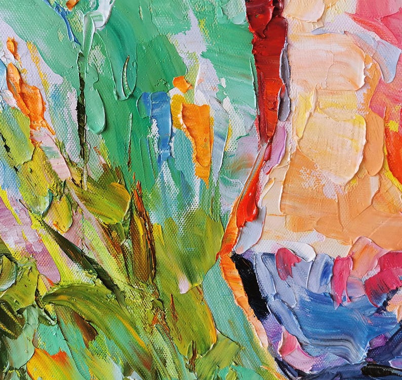 May include: Close-up of an abstract oil painting with thick brushstrokes. The artwork features a vibrant palette of colors, including green, orange, red, yellow, and blue. The textured surface creates a sense of depth and movement, suggesting a floral or landscape theme.
