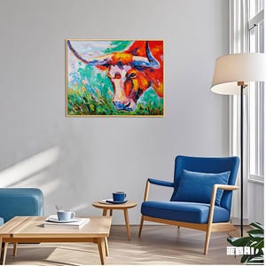 May include: A colorful oil painting of a bull's head with long horns. The artwork features vibrant shades of red, orange, blue, and green, set against a gold frame. The bull's face is the focal point, with detailed brushstrokes.