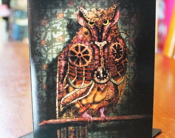 May include: A steampunk-style owl card with a detailed illustration of an owl with gears and clockwork elements. The owl is perched on a branch with a dark background and intricate floral patterns.