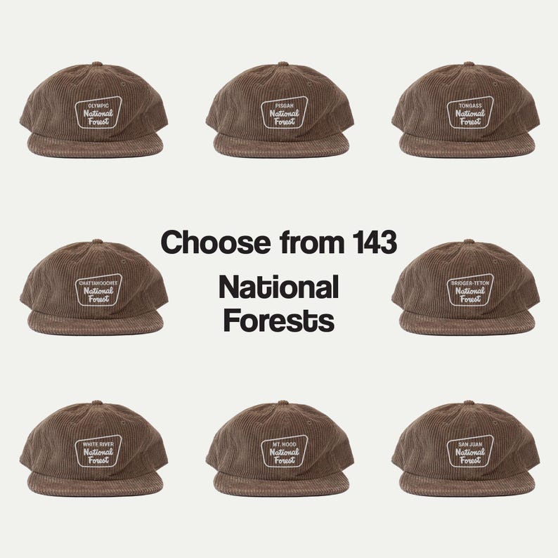 May include: Nine brown corduroy baseball caps arranged in a grid, each featuring a unique embroidered patch with the text National Forest. The central text reads Choose from 143 National Forests, highlighting the variety of available options.