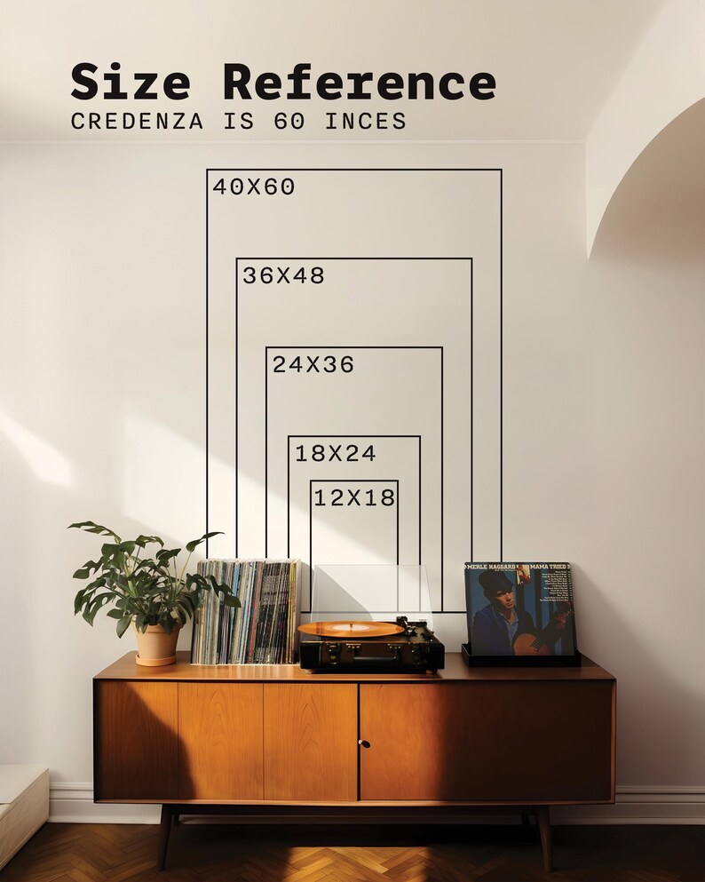 May include: A wall graphic showing size reference rectangles labelled 12x18, 18x24, 24x36, 36x48, and 40x60 inches above a wooden credenza. The text reads Size Reference and Credenza is 60 inces. A plant, vinyl records, and a record player are present.