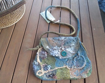 Hand dyed merino and silk felted shoulder bag with inside pocket and button closure. Trendy artisan felted wool and silk small shoulder bag.