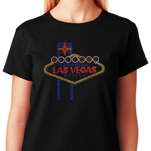 May include: Black t-shirt with a rhinestone design of the iconic "Welcome to Fabulous Las Vegas" sign.