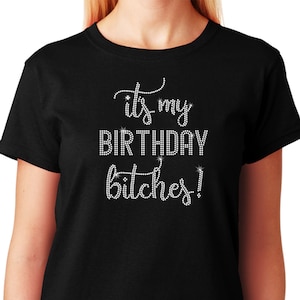 May include: Black t-shirt with the text "it's my BIRTHDAY bitches!" in rhinestones.