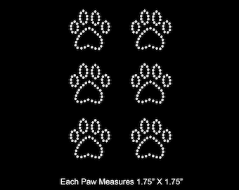 May include: Six white paw print iron-on rhinestone transfers. Each paw print measures 1.75 inches by 1.75 inches.