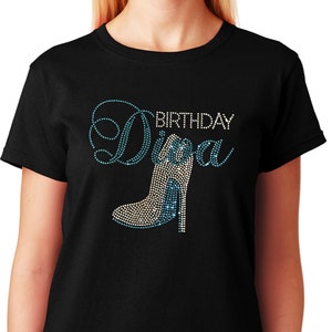 May include: Black t-shirt with a blue and white rhinestone design that says "Birthday Diva" with a high heel shoe graphic.