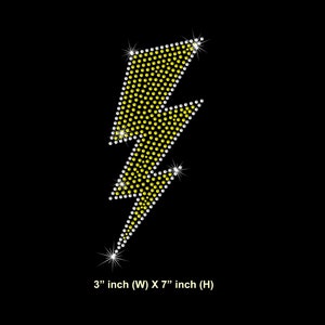 May include: A yellow lightning bolt design made of rhinestones, measuring 3 inches wide by 7 inches tall.