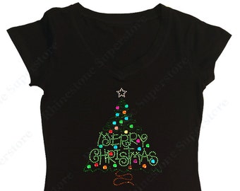 May include: Black t-shirt with a green Christmas tree design made of rhinestones. The tree has colorful lights and the words "Merry Christmas" are spelled out on the tree.