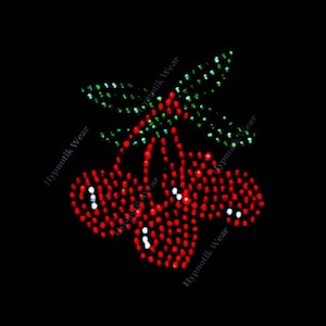 May include: Red and green rhinestone cherry design. The cherries are clustered together with green leaves.