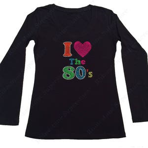May include: Black long-sleeved shirt with a rhinestone design that says "I love the 80's" with a pink heart.