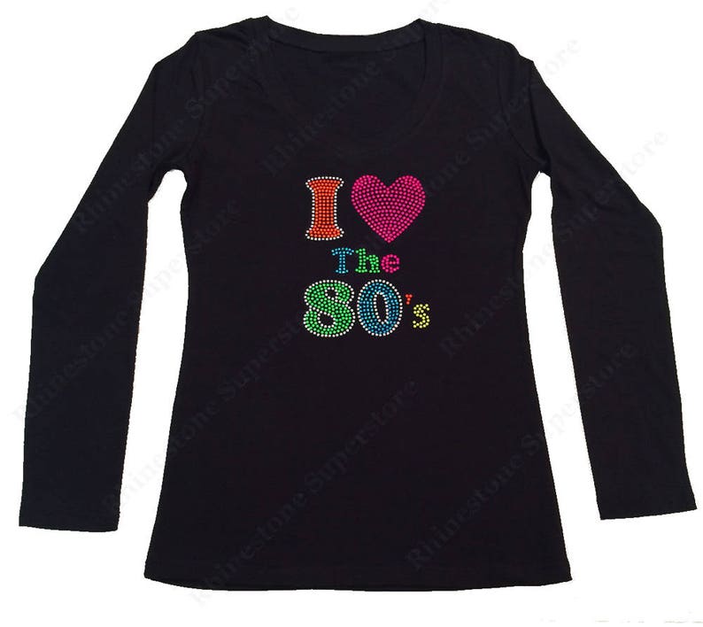 May include: Black long-sleeved shirt with a rhinestone design that says "I love the 80's" with a pink heart.