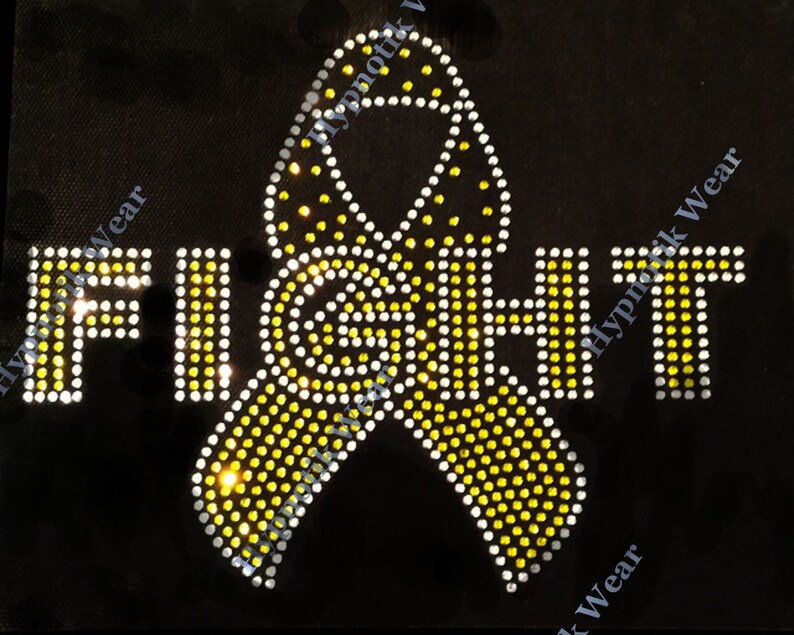 May include: Yellow and white rhinestone design of a ribbon with the word "FIGHT" in rhinestones.